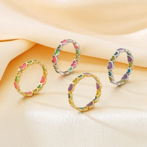 Colorful heart drip oil stainless steel rings on champagne satin background