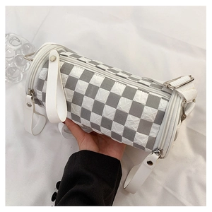 Close-up of cylindrical checkered bag in bubble fabric with silver zipper detail