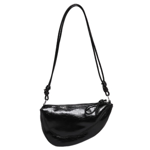 Glossy black leather saddle bag with minimalist knot strap and silver zipper detail