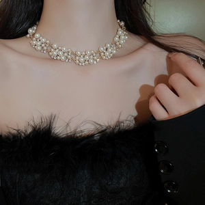 Detail of multi-layer pearl and rhinestone choker necklace with elegant gold chain links