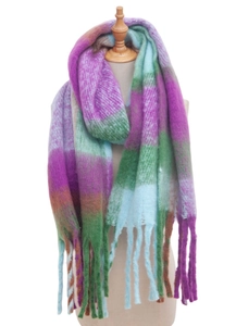 Detail of multi-color plaid knit scarf featuring fringe tassels and thick textured yarn