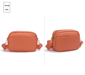 Dettaglio della borsa a tracolla arancione in pelle martellata con zip in metallo
