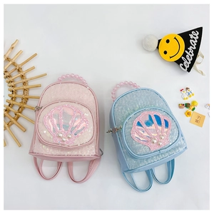 Close-up of sequins, shell pattern and pearl handle on pink and blue kids' backpacks