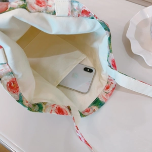 Detail shot of internal phone pocket and thick canvas lining of floral tote bag