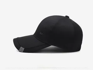 Side view of black baseball cap showing metal nameplate and sport fashion woven label