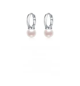 Close-up of minimalist S925 silver earrings with lustrous round pearl drop charms
