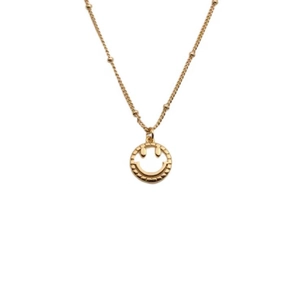 Detailed view of the gold-plated smiley face pendant necklace with cubic zirconia