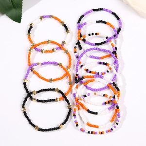 Detail of colorful Independence Day seed bead bracelets with golden star charms and layers