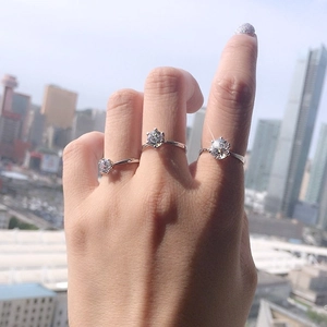 Classic six-prong sterling silver open ring with round cut sparkling moissanite stone
