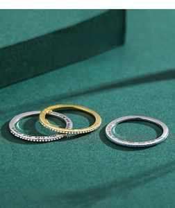 Detailed macro view of S925 silver rings with pavé diamonds and engraved quotes