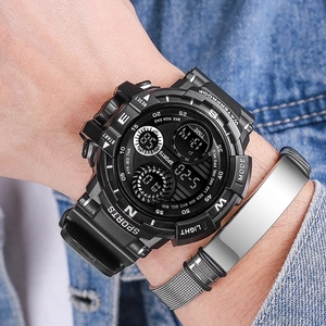 Close-up of black digital sports watch and silver braided steel bracelet on a wrist