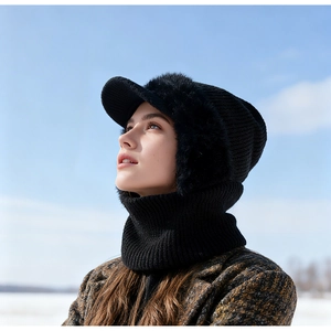 Detail of black knitted thermal set with faux fur earflaps and neck gaiter in winter