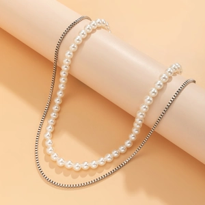 Detail view of hip-hop double-layer necklace with white pearls and silver box chain