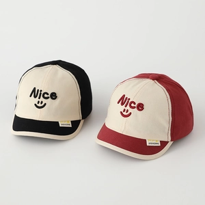 Close-up of Nice embroidery and smiley face on two-tone kids' cotton baseball caps