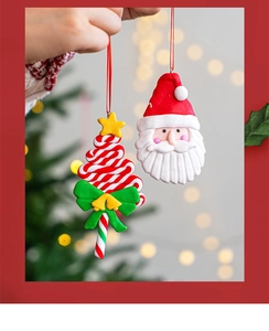 Handcrafted clay Santa and striped Christmas tree ornaments hanging in festive decor