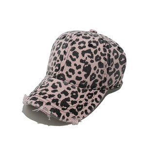 Close-up of pink leopard print baseball cap with distressed brim and retro frayed details