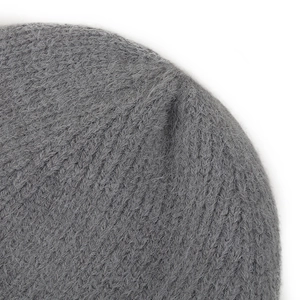 Detailed macro view of dark grey thick knit fabric with soft plush texture and fur lining