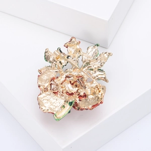 Detail view of the secure metal pin fastener on the back of the golden rose brooch