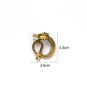 Vintage golden dragon brooch with pearl detail, dimensions 3.3cm by 2.6cm on white background