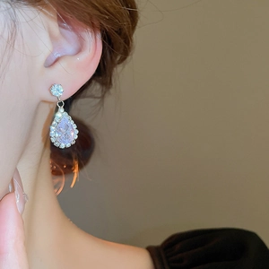 Close-up of a model wearing water-drop zircon earrings with elegant silver finish
