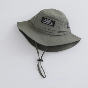 Detail view of army green outdoor sun hat with windproof rope and nature mountain patch