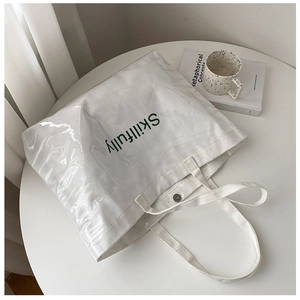 Close-up of clear PVC tote bag with Skillfully print and magnetic buckle closure