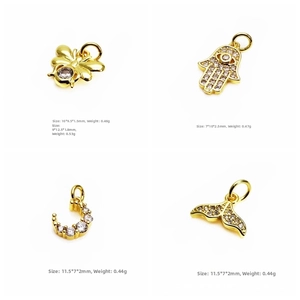 Macro shot of gold star and moon pendants with micro-pave cubic zirconia inlay