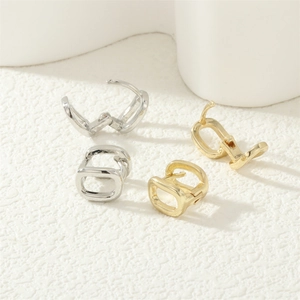 Polished horseshoe hoop earrings in gold and silver showing open and closed states