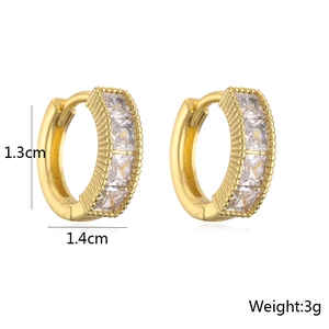 Macro shot of gold-plated huggie earrings with baguette cubic zirconia and size specs