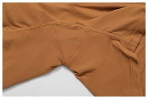 Macro detail of gusseted crotch and reinforced seams on brown high-waisted yoga pants