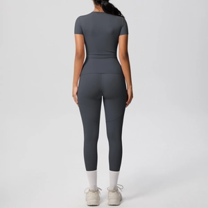Rear view of tight charcoal grey yoga set featuring compression top and leggings