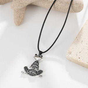 Detailed close-up of realistic frog pendant with black textured accents on a simple cord