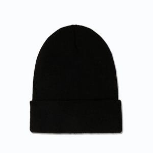 Close-up of black ribbed knit beanie featuring fine stitching and a classic folded cuff