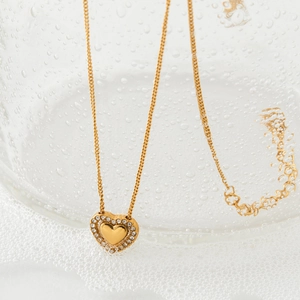 Elegant gold heart pendant necklace with shimmering zircon border on a fine O-chain
