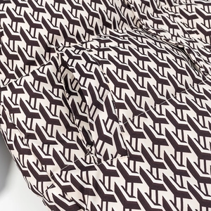 Macro view of geometric Y-pattern fabric and reinforced side pocket on cotton jacket