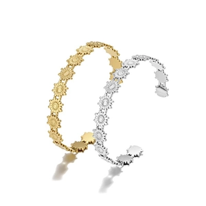 Sunflower pattern open cuff bracelet in gold and silver finish on white background