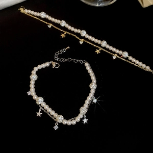 Detail of double-layer pearl bracelet with zircon star charms and adjustable clasp