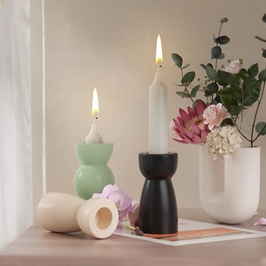 Minimalist geometric ceramic candle holders in matte green, black and cream finishes
