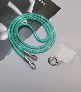 Detail of green sparkly phone lanyard with silver metal clasps and transparent insert