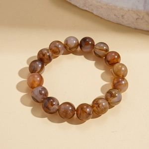 Detailed view of geometric acrylic beaded bracelet with brown marbled amber texture