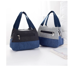 Detail view of thickened canvas lunch bags with front zipper pockets and sturdy handles