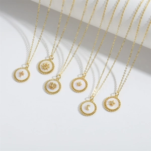 Gothic punk star pendant necklaces in gold finish with cosmic charms on white background