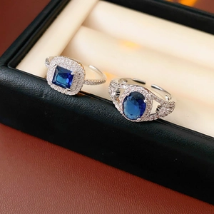 Macro view of adjustable silver rings with square and oval deep blue zircon gemstones