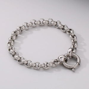 Detail of silver stainless steel chain bracelet featuring ornate Greek meander patterns