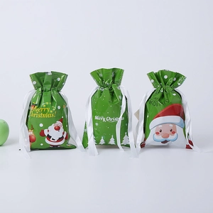 Three green Christmas drawstring gift bags with Santa and reindeer prints on white background