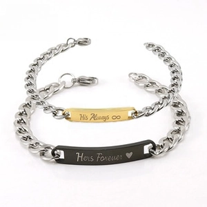 Detail of his and hers stainless steel bracelets with engraved curved plaques and chains