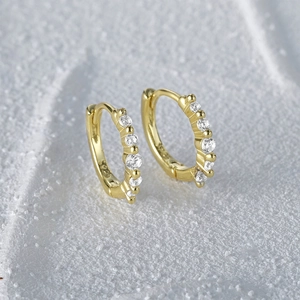 Detailed close-up of S925 sterling silver huggie hoop earrings with sparkling zircon stones