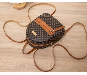 Detailed top view of a brown geometric lattice print backpack with tassel zipper detail