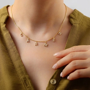 Detail shot of a gold-plated stainless steel necklace with CARMEN cubic zirconia charms