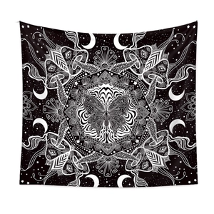 Detail of psychedelic butterfly and mushroom pattern on a black and white mandala tapestry